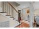Inviting foyer featuring hardwood floors, staircase with wrought iron railing, and stylish decor at 7 Pine Valley Ln., Surfside Beach, SC 29575