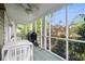 Inviting screened-in porch with a ceiling fan, providing a comfortable outdoor space for entertaining at 7 Pine Valley Ln., Surfside Beach, SC 29575