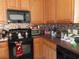 Well-lit kitchen featuring a microwave, oven, and patterned backsplash at 819 Brookline Dr., Myrtle Beach, SC 29579