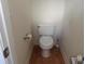 Functional powder room with standard toilet and essential fixtures; compact and efficient design at 819 Brookline Dr., Myrtle Beach, SC 29579