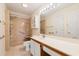 Bathroom featuring an accessible shower with built-in seating and a large mirror with vanity lighting at 820 Fairway Dr. # 1506Hh, Longs, SC 29568