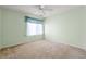 Bedroom featuring neutral carpet, a ceiling fan, and a bright sunny window at 820 Fairway Dr. # 1506Hh, Longs, SC 29568