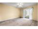 Bedroom featuring neutral carpet, ceiling fan and sliding glass doors to the patio at 820 Fairway Dr. # 1506Hh, Longs, SC 29568