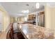 Open-concept kitchen with stainless steel appliances and an island with bar seating at 820 Fairway Dr. # 1506Hh, Longs, SC 29568