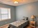 Comfortable bedroom with ceiling fan, natural light from the window and side table with a lamp at 901-9 West Port Dr. # 907, North Myrtle Beach, SC 29582