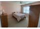 Cozy bedroom features a ceiling fan, natural light, and neutral carpeting at 901-9 West Port Dr. # 907, North Myrtle Beach, SC 29582