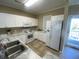 This is an open kitchen featuring white appliances and cabinets with updated countertops and flooring at 901-9 West Port Dr. # 907, North Myrtle Beach, SC 29582