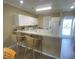 Bright kitchen with white appliances, cabinets, and an eat-in bar, offering a fresh and inviting space at 901-9 West Port Dr. # 907, North Myrtle Beach, SC 29582