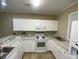 Bright kitchen features modern white appliances and updated countertops and floors for a stylish cooking space at 901-9 West Port Dr. # 907, North Myrtle Beach, SC 29582