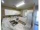 The kitchen is equipped with white cabinets, modern appliances, and marble countertops at 901-9 West Port Dr. # 907, North Myrtle Beach, SC 29582