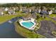 Aerial view of a community pool with lounge chairs, umbrellas, and parking spaces nearby at 932 Jackline Place # 103, Murrells Inlet, SC 29576