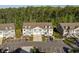 Aerial view of a townhouse complex featuring ample parking, lush greenery, and well-maintained landscaping at 932 Jackline Place # 103, Murrells Inlet, SC 29576