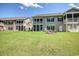 A backyard featuring a screened porch, perfect for relaxing and enjoying the outdoors at 932 Jackline Place # 103, Murrells Inlet, SC 29576