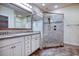 Bathroom featuring tile floors, double vanity, large mirror, and glass enclosed shower with bench at 932 Jackline Place # 103, Murrells Inlet, SC 29576