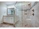 Spacious bathroom boasts a glass enclosed shower, double vanity, tile floors, and stylish fixtures at 932 Jackline Place # 103, Murrells Inlet, SC 29576