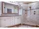 Modern bathroom with tile floors, double sink vanity, and glass enclosed shower with bench at 932 Jackline Place # 103, Murrells Inlet, SC 29576