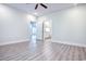 Large bedroom with hardwood floors, ceiling fan, and views into the bathroom at 932 Jackline Place # 103, Murrells Inlet, SC 29576