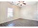 A bedroom features wood-look floors, a ceiling fan, and a window for natural light at 932 Jackline Place # 103, Murrells Inlet, SC 29576