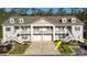 Charming townhouse with gray siding, white trim, a two-car garage, and a welcoming staircase to the entrance at 932 Jackline Place # 103, Murrells Inlet, SC 29576