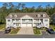 Charming townhouse featuring a double garage, balcony, and well-manicured landscaping at 932 Jackline Place # 103, Murrells Inlet, SC 29576