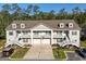 Charming townhouse featuring a double garage, balcony, and well-manicured landscaping at 932 Jackline Place # 103, Murrells Inlet, SC 29576