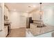 Well-lit kitchen featuring stainless appliances, granite counters, white cabinets, and wood-look flooring at 932 Jackline Place # 103, Murrells Inlet, SC 29576
