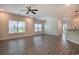 Spacious living room with wood floors, modern lighting, and large windows for natural light at 932 Jackline Place # 103, Murrells Inlet, SC 29576