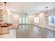 Bright living room featuring wood floors, modern lighting, and a seamless transition to the kitchen at 932 Jackline Place # 103, Murrells Inlet, SC 29576