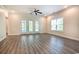 Bright, open living space with wood floors and French doors leading to an outdoor area at 932 Jackline Place # 103, Murrells Inlet, SC 29576