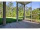 This home's screened-in patio features a view of the large backyard and surrounding greenery at 932 Jackline Place # 103, Murrells Inlet, SC 29576