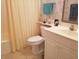 Bright bathroom featuring a vanity, sink, toilet and curtained shower at 1000 Ray Costin Way # 108, Murrells Inlet, SC 29576