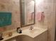 Neutral bathroom featuring seashell wallpaper, white vanity, and decorative mirror at 1000 Ray Costin Way # 108, Murrells Inlet, SC 29576