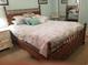 Bedroom with a wooden bed frame and a mirror at 1000 Ray Costin Way # 108, Murrells Inlet, SC 29576