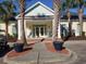 Charming clubhouse exterior with rocking chairs, well-manicured landscaping, and covered porch at 1000 Ray Costin Way # 108, Murrells Inlet, SC 29576