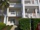 View of the condo's exterior showcasing multiple levels with private balconies and well-maintained landscaping at 1000 Ray Costin Way # 108, Murrells Inlet, SC 29576