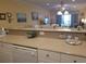 Partial kitchen view into the living area, showing countertops and white cabinets with decorative elements at 1000 Ray Costin Way # 108, Murrells Inlet, SC 29576
