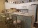 Bright kitchen featuring white cabinets, a breakfast bar with seating, and modern appliances for convenience at 1000 Ray Costin Way # 108, Murrells Inlet, SC 29576