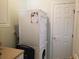 Stacked washer and dryer in a laundry area with a clean, functional design and nearby door at 1000 Ray Costin Way # 108, Murrells Inlet, SC 29576