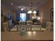 View from the kitchen into the dining/living area with a sliding door for outside balcony access and ample seating at 1000 Ray Costin Way # 108, Murrells Inlet, SC 29576