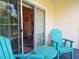 Inviting patio with blue Adirondack chairs and table perfect for relaxation at 1000 Ray Costin Way # 108, Murrells Inlet, SC 29576