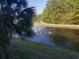 Scenic pond view with fountain, lush greenery, and walking path at 1000 Ray Costin Way # 108, Murrells Inlet, SC 29576