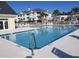 A beautiful pool with clear blue water with lounge chairs, and palm trees at 1000 Ray Costin Way # 108, Murrells Inlet, SC 29576