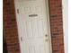 A white storage door with red brick trim and a black sign that reads: STORAGE 108 at 1000 Ray Costin Way # 108, Murrells Inlet, SC 29576