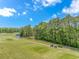 Aerial view of golf course with mature trees, fairways and two golf carts at 1033 World Tour Blvd. # 203, Myrtle Beach, SC 29579