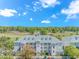 Aerial view of a condominium complex with a golf course backdrop under a blue sky at 1033 World Tour Blvd. # 203, Myrtle Beach, SC 29579