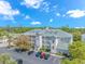 Exterior of a multi-story building with balconies, parking, and well-maintained landscaping at 1033 World Tour Blvd. # 203, Myrtle Beach, SC 29579