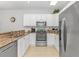 Kitchen with granite counters, stainless steel appliances, and crisp white cabinetry at 1033 World Tour Blvd. # 203, Myrtle Beach, SC 29579