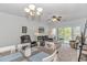 Bright living room with comfortable seating, ceiling fan, dining area, and access to a balcony with scenic views at 1033 World Tour Blvd. # 203, Myrtle Beach, SC 29579