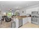 Open-concept kitchen flows into the living area, which features a sliding glass door at 1033 World Tour Blvd. # 203, Myrtle Beach, SC 29579