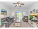 Comfortable living room featuring plush seating, a ceiling fan, neutral decor, and access to a balcony with green views at 1033 World Tour Blvd. # 203, Myrtle Beach, SC 29579